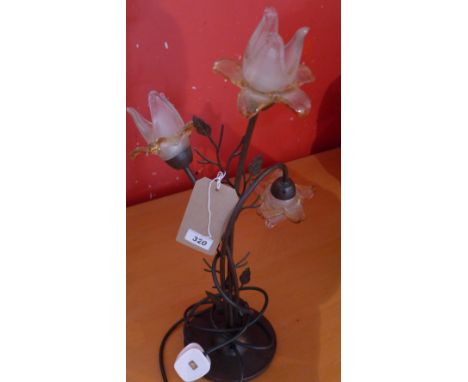 A 3 branch table lamp of naturalistic design and floral shades 