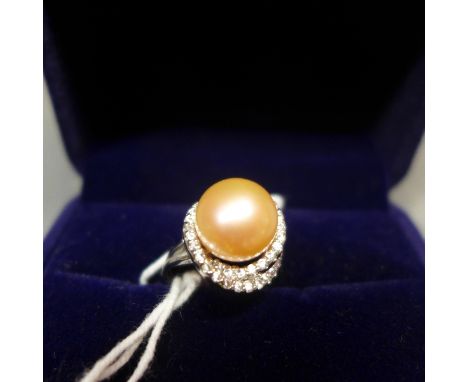 A white metal, pearl and diamond inset ring, indistinctly stamped to shank 