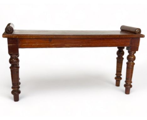 A Victorian mahogany hall bench
The rectangular seat with scroll ends, on ring turned tapering legs, 92cm wide, 28cm deep, 49