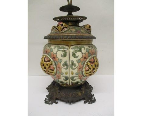 A Zsolnay Pecs pottery and brass oil lamp with pierced, domed ornament decorated in green, pink and red, with a removable res