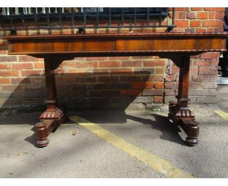 A Regency rosewood sofa table with two frieze drawers over twin rectangular columns with carved ornament and turned, carved f