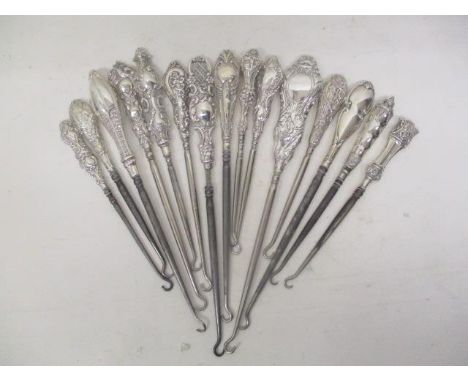 Fifteen Victorian and later silver and white metal handled button hooks, each with embossed decoration 