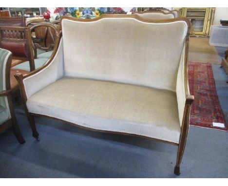 An Edwardian mahogany inlaid two seater sofa and two matching armchairs 