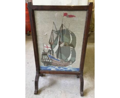 A glazed dark oak tapestry firescreen depicting a galleon.  