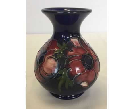 A vintage Moorcroft vase. Peony pattern on blue ground. Impressed marks to base 12.5cm (5 inches) tall.