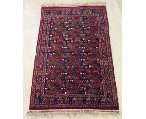 A small vintage rug of blue and red colouration.  Approx. 150cm x 100cm