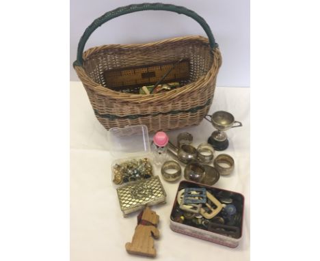 A wicker basket containing a good quantity of miscellaneous items. To include silver plated items, vintage buttons & buckles,