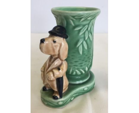 A Sylvac posy vase with a dog wearing a bowler hat. Model #2660, in biscuit and green colourway. Circa 1960's. Approx 10.5cm 