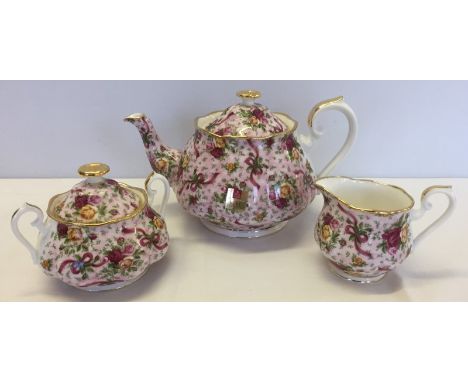 A Royal Albert Old country roses Ruby Celebration pink Chintz teapot, milk jug and sugar bowl. With gilt decoration. 