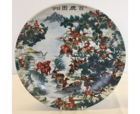 An oriental ceramic charger with deer design.  Approx. 34cm diameter.