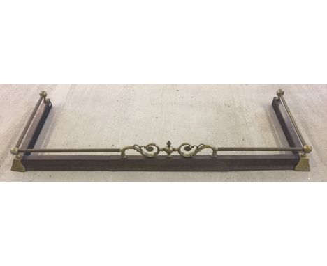 A vintage extending brass fire fender. With ball and floral design. 