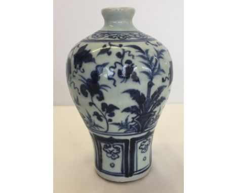 A blue and white Chinese heavy ceramic vase with hand painted decoration.  Approx. 20cm tall.