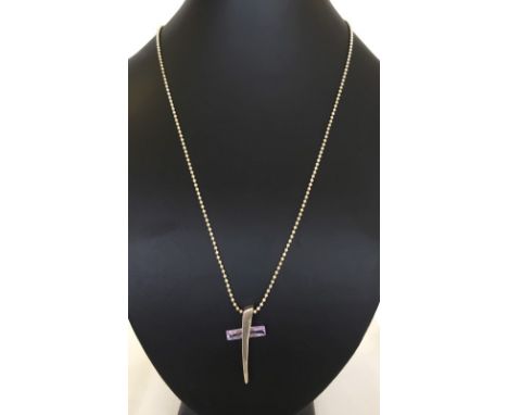 Modern design silver cross and chain. The cross beam is made of amethyst that cuts through the silver. Slight chip to the end