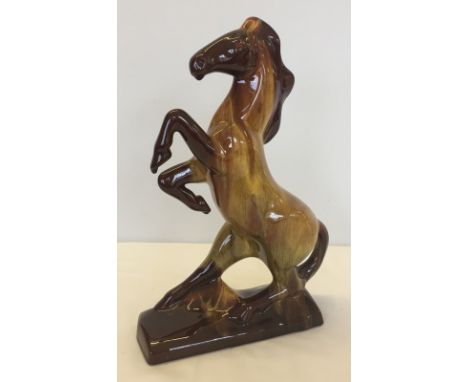Large ceramic rearing horse In variegated brown & gold colours. Measures 36cm tall.