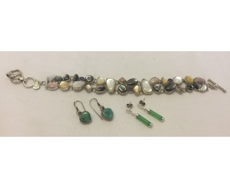 A 925 silver bracelet set with shell and natural stones. Together with 2 pairs of silver earrings, one set with turquoise and