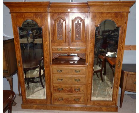 A Victorian pollard oak breakfront triple wardrobe with moulded cornice, 2 arched bevelled mirror panel side robes, central f