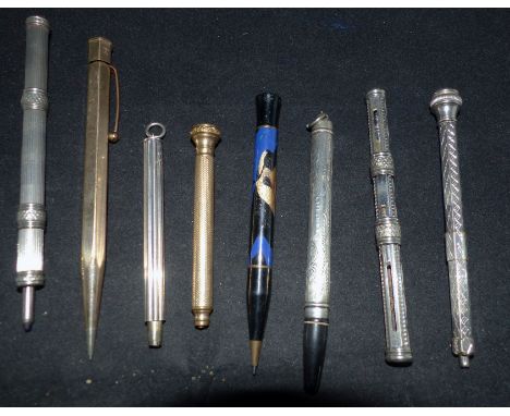 A gilt cased pencil with compass finial; 7 others
