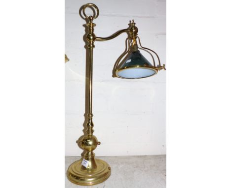 An adjustable brass desk lamp with opaque green overlaid glass shade, 24"