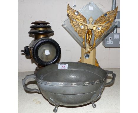 An Art Deco table lamp depicting a winged female, in simulated ivory and gilt; a coach lamp; an "English Pewter" bowl