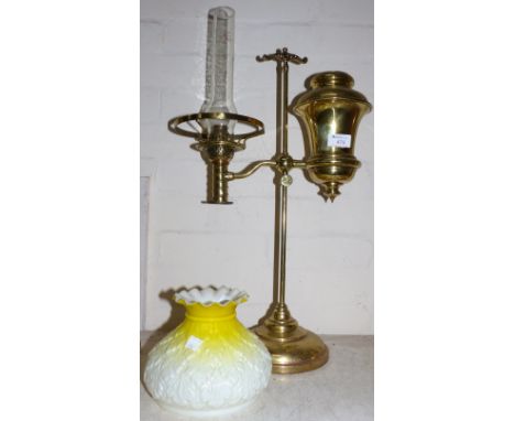 A brass student lamp with ornate yellow and opaque white glass shade, 21"