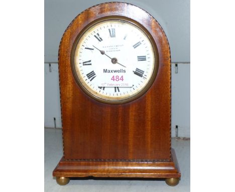 A small Edwardian inlaid mahogany arch top mantel clock
