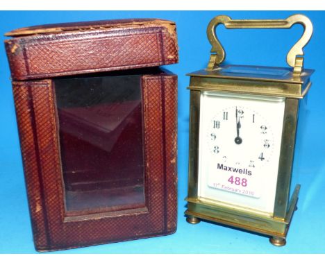 An early 20th century brass carriage clock with white enamel dial and timepiece movement