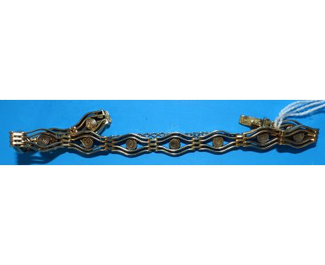 A yellow metal shaped link gate bracelet, unmarked, tests as 9 carat