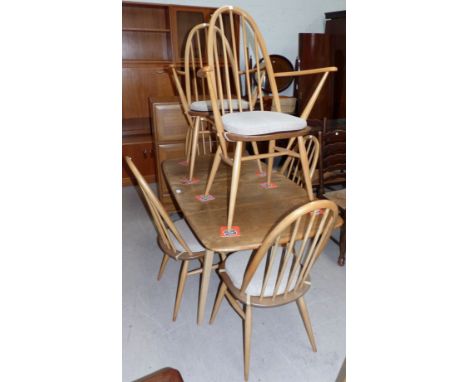 An Ercol light elm dining suite comprising rectangular drop leaf table and 6 (4 + 2) chairs