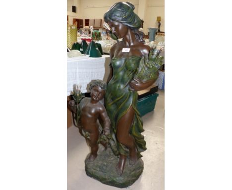 An Art Nouveau style free standing bronzed lamp, woman and child