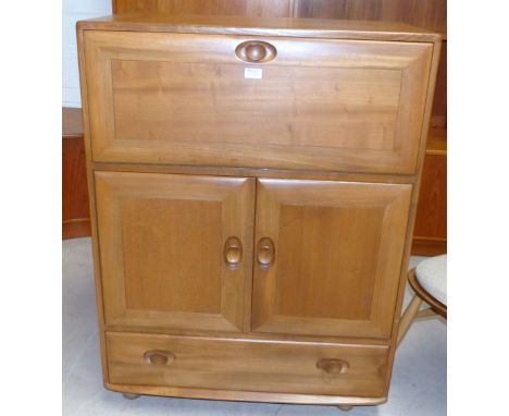 An Ercol light elm cocktail cabinet with fall front, twin door cupboard and base drawer