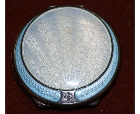 An Art Deco silver and enamel powder compact