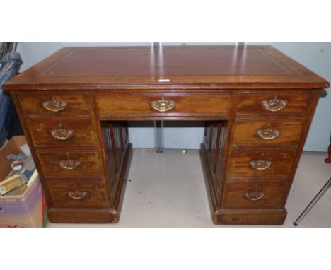 An oak twin pedestal desk fitted 9 drawers, inset leather top, 48"