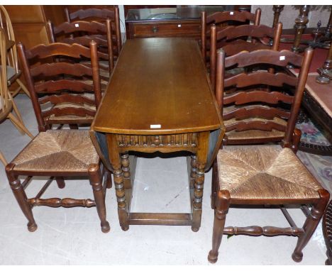 A distressed oak oval drop leaf gate leg table with single drawer under, and 6 ladder back chairs with rush seats