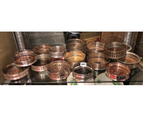 SHELF OF PREDOMINANTLY 19TH CENTURY SHEFFIELD PLATED BOTTLE COASTERS, VARIOUS SIZES