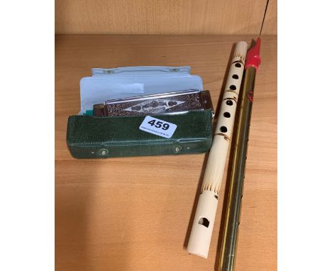 A Honer harmonica together with two flutes.