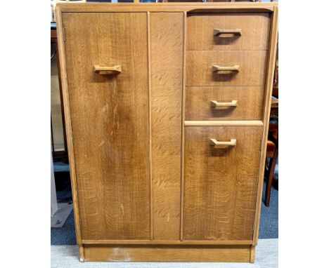 A 1960's G plan light oak tallboy, with push action cupboard door 88 x 122cm.