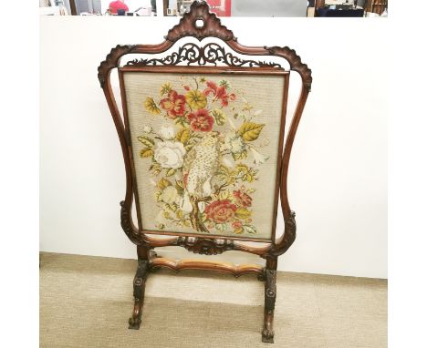A superb large carved mahogany tapestry behind glass fire screen, largest 129 x 75cm. Prov. Little Wakering Hall