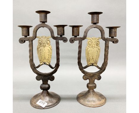A pair of brass and iron handmade arts and crafts candelabra, H. 34cm.