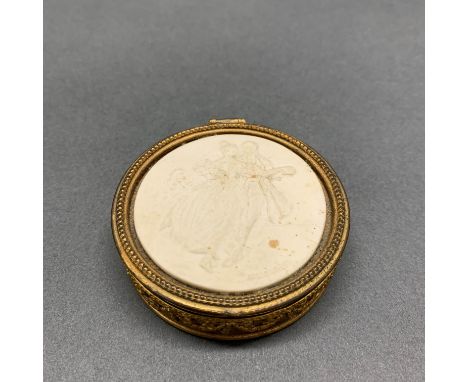 A gilt metal box with Goldscheider porcelain inset, Dia. 6.5cm.