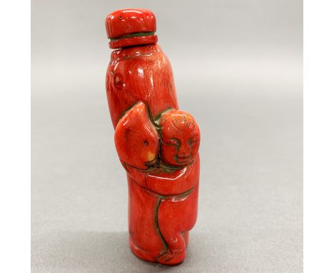 A Chinese carved coral snuff bottle, H. 10.5cm.