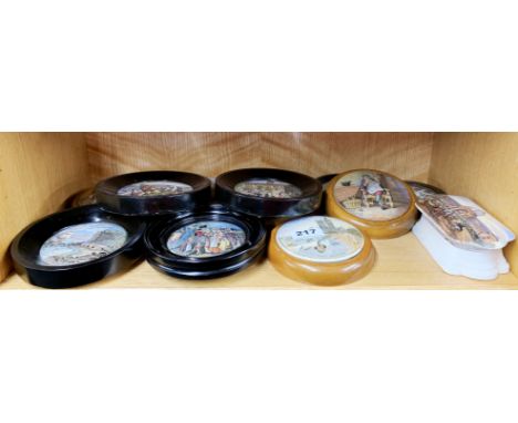 A collection of 19thC Prattware pot lids.