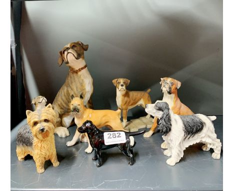 A group of ceramic and resin figures of dogs including Beswick, tallest 22cm.