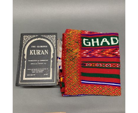 Islamic interest. A volume of the Qur'an in Arabic and English together with a handwoven prayer mat.