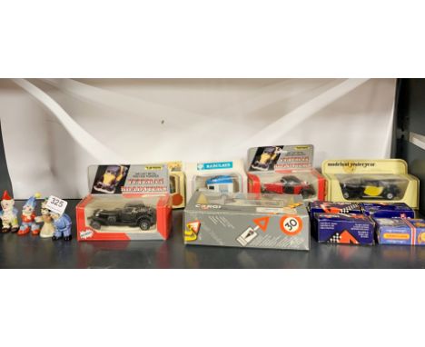 A group of four 1950's Wade figures with a group of diecast small vehicles.