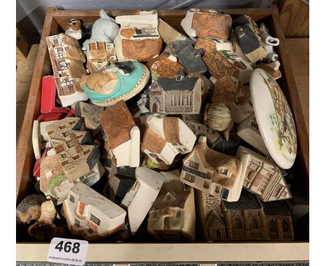 A large quantity of ceramic cottages and other items.