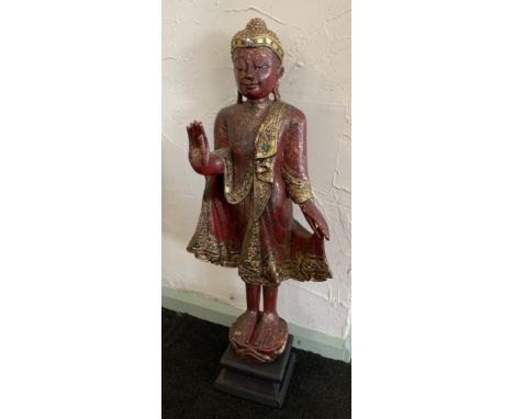 A gilt and red composition statue of Buddha 86cm on plinth 