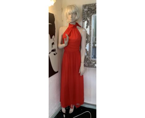 A full size composite female mannequin - no base but complete with wig and red dress 