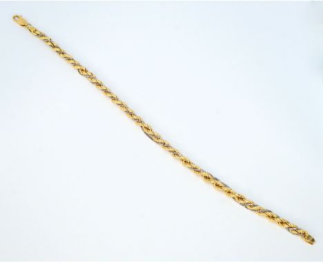 14 K Gelbgold, gestempelt. Gegliedertes, gedrehtes Kordelarmband im Verlauf mit umwickelter dünner Venezianerkette in Weißgol