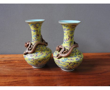 PAIR OF CHINESE FAMILLE ROSE YELLOW-GROUND 'DRAGON' VASES QING DYNASTY, 19TH CENTURY with apocryphal Qianlong red seal marks 