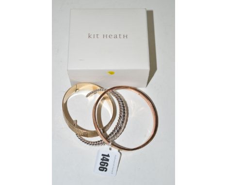 A 9ct. gold bangle; a giltmetal bangle; and a silver bangle with gadrooned design.